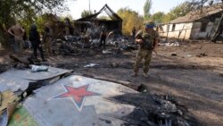 Ukrainian soldiers inspect the crash site of a downed Russian warplane in Kostyantynivka, Donetsk region, Ukraine, on October 5.