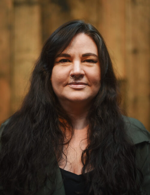 A headshot image of Jane Fahy smiling towards the camera.