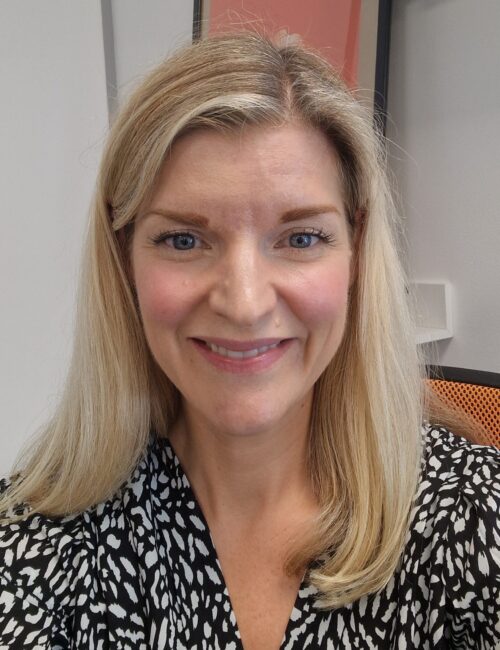 A headshot image of Lucy Bennett smiling towards the camera.