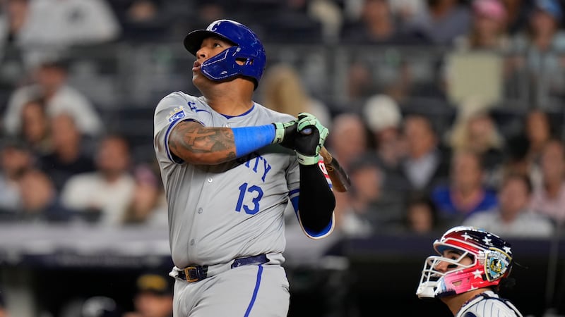 FILE - Kansas City Royals' Salvador Perez (13), left, and New York Yankees catcher Jose...