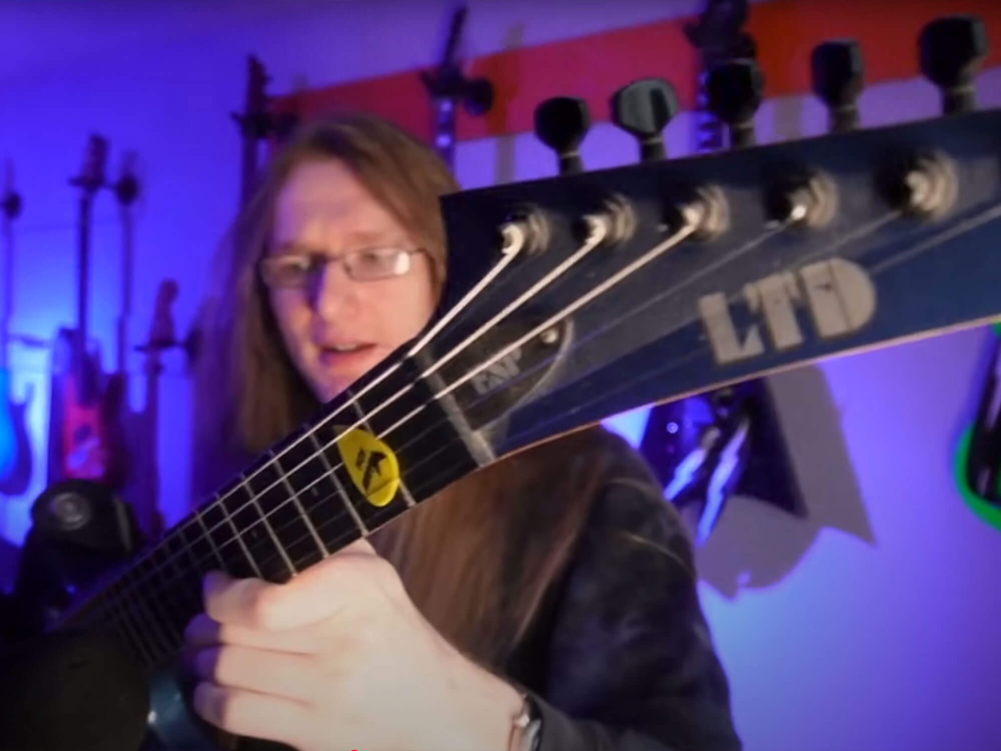 YouTuber KDH holds up an LTD electric guitar