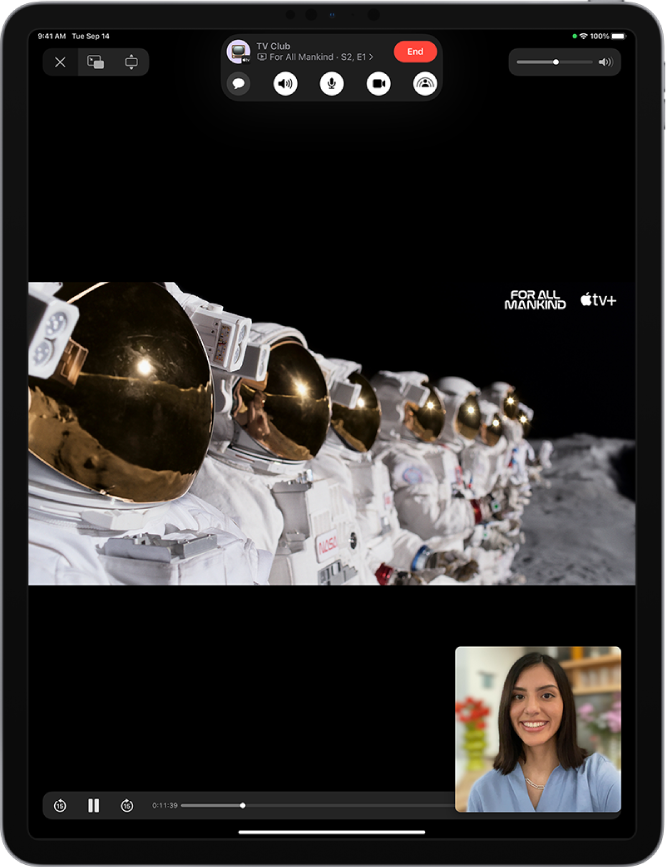 A FaceTime call, showing Apple TV+ video content being shared in the call. The FaceTime controls are shown at the top of the screen, the video is playing just below the controls, and the playback controls are at the bottom of the screen.