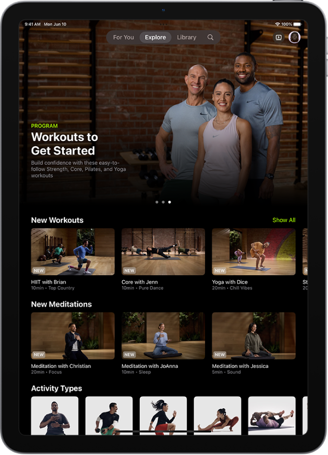 The Explore screen in Apple Fitness+ showing a featured workout program, new workouts and meditations, and available activity types.