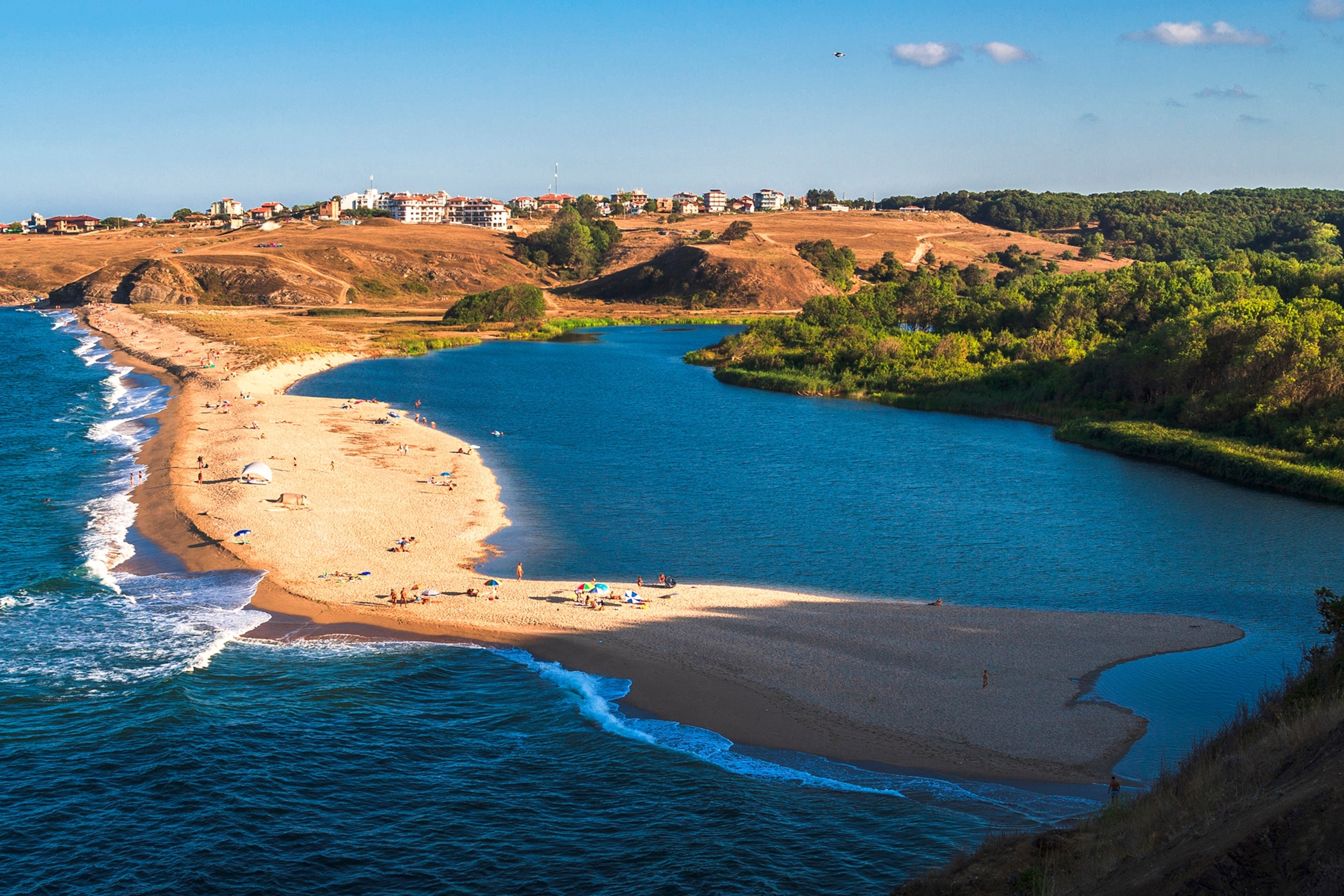 Stretch of sand extending across a river creating a beach