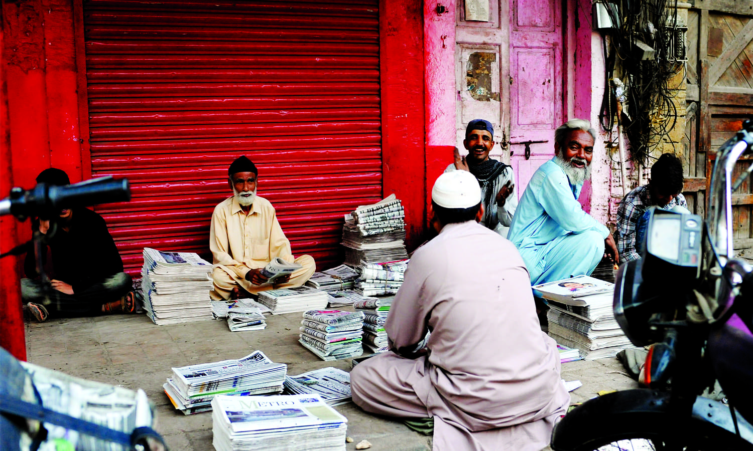 Newspaper hawkers in the New Challi area of Karachi, surrounded by stacks of the day’s newspapers and magazines, which will later be distributed throughout the city. Also located in New Challi is the Haroon Chambers building. This was the headquarters of Dawn Karachi from August 14, 1947 where the newspaper was edited and printed, until the Dawn offices were shifted to Haroon House on Dr Ziauddin Ahmed Road on October 27, 1968, which remains the site of the Dawn press in the city. (photo: Arif Mahmood/ Dawn White Star)