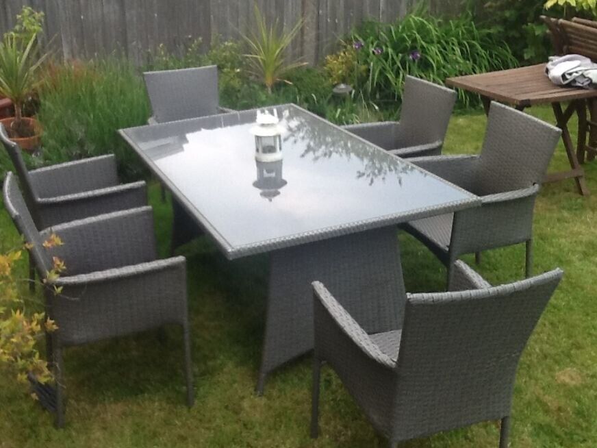 large glass-top rattan garden table with six chairs | in Willesden