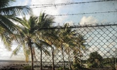 The island nation of Nauru with an overlay of a barbed fence in the foreground.