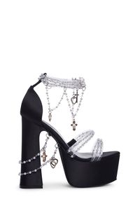 cuz you're a vision of divinity, babe. These chunky platform heels have a matte satin construction, adjustable velcro strap closures, and pearl beaded straps with cross and heart charms.