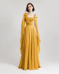 Draped Mustard Dress Product Details Flared chiffon mustard dress with draping details and bow design on the shoulders. Remark: Can accept slight modification. Dress Length from waist to hemline: 120cm