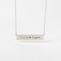 Empower your style with our "Teach + Inspire" Inscriptions Bar Necklace! Echo your passion for making a difference with this stunning 16-19" silver necklace.