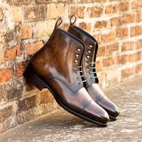 Stunning lace-up Derby Boots for men by Civardi. The Percy Derby Boot is hand-crafted in brown marble patina leather and is produced on a fiddle-waisted leather sole complete with brass toe-taps! Customize this design online and choose from an endless range of patinas and other options. Free shipping on all orders! #customboots, #derbyboots, #patinaboots