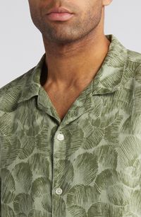 Leafy, abstract patterns invite cooling breezes in a camp shirt made from lightweight linen and styled for relaxing on sunny days. 29 1/2" length; 46" chest (size Medium) Front button closure Notched collar Short sleeves 100% linen Machine wash, tumble dry Imported