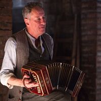 In this scene, Hans is playing his accordion. This is his favorite pastime. It is also a means of income during the winter when he plays in local pubs.