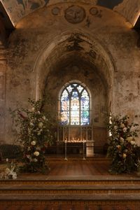 A stylish wedding at Bristol Wedding venue, The Mount Without. The Mount Without is a spectacular old church, recently renovated as a wedding and events space, in the heart of Bristol. Celebrant led ceremony by Tara the celebrant, and organic, wild florals by Tulips and Cactus. Church wedding venue. LGBTQ+ wedding at The Mount Without. Two brides getting married in wedding ceremomy. Bride wearing long sleeve dress with veil, low back wedding dress. Bride wearing pleated jumpsuit. LGBTQ+ wedding outfit ideas. Editorial fairytale gothic romance wedding in converted church. Editorial wedding photography by London Wedding Photographer Esme Whiteside Photography. WLW wedding photographer Esme Whiteside