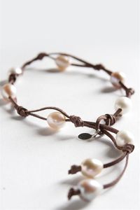 Authentic boho style with a twist! Our 9 Fresh Water Pearl Wrap features nine white freshwater pearls set in a beautiful brandy-colored leather with pearl sizes varying from 6 - 14mm. This chic jewelry was featured in Accesories Magazine as the Best Friendship Bracelet and, just like a good friend, is a rare find. Wrap