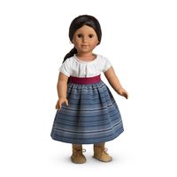 The Indigo Skirt and Camisa (also called Josefina's School Outfit) was introduced to Josefina's Collection in 1997 and retired in 2015. The outfit is associated with the book Josefina Learns a Lesson. Retail cost was $20 and was later increased to $28. Multi-blue striped thick indigo skirt. Velcros at back waist. White camisa (blouse). Cotton lace trim at sleeves and neckline; neckline also features a decorative tuck. Velcros up the back. Woven dark red waist sash. Three tassels at the end. ...