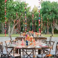 25 pom pom garlands, fun, vibrant event & wedding decorations. Each pom pom garland is 1.50 metres (5ft) long, has 20 pom poms along it, and a tassel at each end. Handmade in Mexico in the mountains of Chiapas. Ship from our UK warehouse. Next day delivery available.