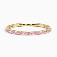 Luxe Ballad Pink Sapphire Wedding Ring - 14K Yellow Gold. This ring features scalloped pavé pink sapphires in elegantly sculpted prongs that extend three-fourths of the way around the band.