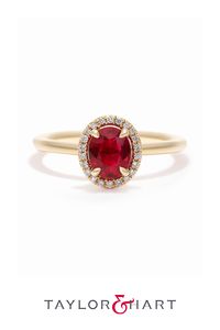 Yellow gold halo engagement ring set with an oval ruby and diamond halo #engagementring #ruby #halo #diamond #unique