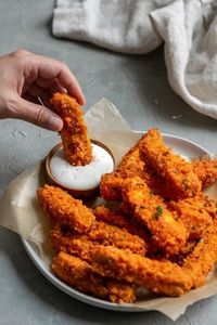 Crispy baked buffalo tofu wings dipped into vegan bleu cheese dressing #vegan #buffalotofuwings