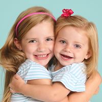 Say "I love you" in style with this adorable sibling photo idea. Recreate the look with matching shirts and pink & red accents. Sisters by birth but best friends by choice!