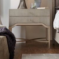 Curvy and elegant, the Elixir Two-Drawer Nightstand combines metal trim and a metal X-stretcher in a champagne silver finish with a serene gray beige finish applied to lightly sand-blasted walnut veneer for textural appeal. Elixir is a casual contemporary collection that, as its name implies, exudes a feeling of comfort, simplicity, and well-being. While Elixir has crisp, clean lines, character, and visual interest are also achieved through the use of texture. Textural interest comes from the us