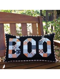 This pillow sham is designed to be made with a mini charm pack of 2½" squares, but feel free to substitute scraps of your favorite Halloween prints.