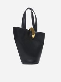 Jacquemus' Le Petit Bambola mini asymmetric bucket bag in black leather featuring an adjustable shoulder strap, double top handles, central metal ring fastening, logo plaque on the front, interior zip pocket, cotton canvas lining and gold-tone metal hardware. Composition: 100% leather