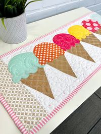 This table runner is the perfect addition to any summer party! Decorate for summer with these cute and fun ice cream cones. Don't forget to make one a double-scoop!