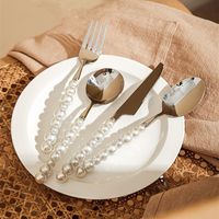 Introducing the 4Pcs Pearl Cutlery Stainless Steel Flatware, the perfect addition to your dining table. Crafted with precision from high-quality stainless steel, each piece features a stunning pearl-inspired handle that exudes elegance and sophistication. Whether you're hosting a dinner party or enjoying a meal with your family, this flatware set is sure to impress. Material: Stainless Steel Size: Varies Care: Hand washes only. Imported