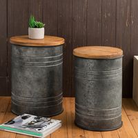 Add rustic and industrial charm to your living space with the Glitzhome Industrial Farmhouse Round Storage End Tables. These end tables come in a set of two, featuring a sturdy iron drum base with a removable pine wood top.