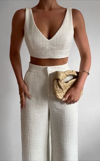 Channel major Elle Woods energy in the Adelaide Two Piece Set. It’s comprised of a crop top and wide leg pants made from a stunning soft tweed fabric. The top is shaped with slender straps, a deep V-neckline and secures with a line-up of concealed hook and eye closures. The pants take a leg-lengthening form in their high-rise fit and loose wide leg style. Pair it with some heeled sandals and a mini bag to match for a chic look! Shop all Showpo. Product Details Top Crop top Hook and eye closure o