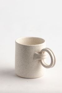 The famous Double Wrap Handle Mug has a new variation and we are here for it! Combining the double wrap handle mug and our classic mug into one piece. Coming in two colors; Sage and Taupe Designed in Steamboat Springs, CO. and handmade in our potter house in Turkey by Turkish locals and Afghan refugees. 4" Tall 3" Diameter - ﻿not including handle Two Color Options: Sage + Taupe Microwave Safe