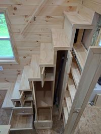 These Tiny House Stairs have plenty of storage. Three drawers, a large storage compartment, a broom closet, a pull-out pantry, and two small cupboards.