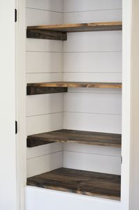 Create a beautiful farmhouse style pantry makeover by adding DIY shiplap and stained wood shelves. This custom look can make any pantry stunning and functional at the same time! #pantry #farmhousepantry #pantrymakeover #shiplap #farmhousestyle #decor