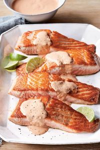 Ina Garten's Seared Salmon With Spicy Red Pepper Aioli is made with salmon fillets, garlic, chipotle pepper, lime juice, roasted red peppers, mayonnaise, and olive oil. This delicious seared salmon recipe creates a tasty dinner that takes about 20 minutes to prepare and can serve up to 4 people.