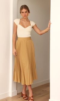 This pleated skirt will look lovely paired with any top for any weather. The beige coloring is a wonderful option to style all year round. The pleated design adds more texture and shape while the material keeps the folds crisp and feels smooth on the skin. The thick waistband creates a contrast between the skirt and any top when tucked in. Pleated skirt Poplin Midi Front slit Elastic waistband Length: 31 1/2" Waist: 13 5/8" Self : 96% Polyester, 4% Spandex Hand wash cold. Dry flat. Low iron, or