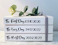 Beautiful, personalised book stacks for wedding table decor. Each book displays the First Day (day you met or First Date), the Yes Day (Engagement Date) and the Best Day (your Wedding Day date). Whilst being a beautiful piece that you can take home as a stunning, neutral decor ornament for your home afterwards- it also will create a talking point amongst your guests. This also makes a lovely Valentines gift to mark those special points in your relationship. FINISH: Different finishes can be chosen to suit decor styles- you can add an artificial eucalyptus sprig for green hues or a large flower for soft dusky pink hues or add a monogram with the bride and groom's initials or simply leave your book stack plain. There are 3 font colours: black, dark grey or bronze. You can also choose soft gr