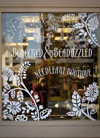 BEDECKED & BEADAZZLED | This painted window may have been seen in winter but these simple floral & foliage shapes would look great as a #SpringWindowDisplay especially in a nice green hue. #springwindowdisplay #visualmerchandising