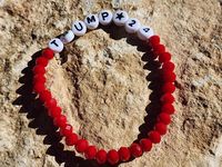 This bracelet will help you to show your support in the republican party voting in 2024. Trump 2024 is read on this red faceted bead bracelet.