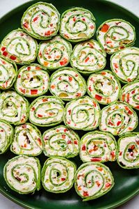 These Christmas Pinwheels are an easy appetizer made in 15 minutes! Festive tortilla roll-ups with cream cheese, ranch, and crunchy veggies.