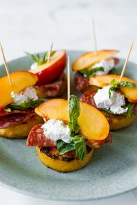 Sweet nectarines, grilled polenta, feta cheese, salami, and basil come together for these Polenta Nectarine Feta Bites. #polentabites #grilledpolenta #polentanectarinefetabites #reluctantentertainer