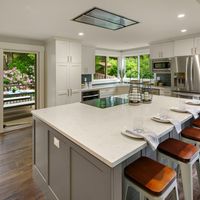 Want a Kitchen Island with increased functionality? Consider moving your stovetop and oven to the island and installing a recessed hood fan to keep the design minimalist and clean!