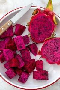 Learn how to make a pitaya bowl (also called pitahaya, pithaya and dragon fruit smoothie bowl) with this easy recipe. This Pitaya Bowl recipe is made with red dragon fruit, frozen bananas and berries, and oat milk. Pitaya bowls make a light vegan breakfast, afternoon snack, post workout nourishment, and a healthy chilled dessert.