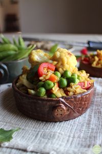 Vegetable fried rice in bowl with peas, cauliflower, and bell pepper.