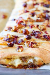 This beautiful Harvest Breakfast Braid is perfect for breakfast, brunch, or even dinner! Layers of sausage, apple, and havarti cheese make for the perfect sweet and salty combo. It's all topped with cranberries and pecans in a sweet orange marmalade glaze.