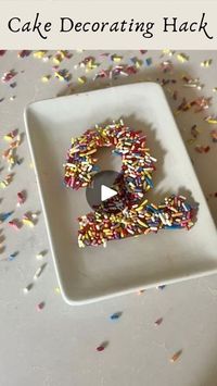 1M views · 1.5K reactions | The easiest hack to elevate your cakes! So simple and only two ingredients. Learned this tip from the amazing @mrshollingsworths 🤍

⭐️Drop a CAKE below and I will send you the piping tool and sprinkles I use!⭐️

Just take:
1/3 cup chocolate chips 
1/2 cup sprinkles (I used dye-free)

Decorate your cakes, desserts, charcuterie boards, etc! You can use chopped nuts, freeze-dried fruits, seeds, coconut, etc.

1️⃣Melt chocolate on stovetop on low heat until completely melted.
2️⃣Pour melted chocolate into a piping bag or tool (you can even use a ziploc bag).
3️⃣Place sprinkles on a flat plate and spread them out. Pipe chocolate over the sprinkles to form number or letter of choice. 
4️⃣Place in the refrigerator or freezer to quickly set. You can even make these ahe