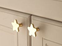 These adorable star shaped knobs would be perfect for a nursery or child's bedroom.  They are made from solid brass so they have been designed to last.  They would be a great way to add an air of whimsy and magic to the interior space. Size: 31mm W x 19mm H (single hole) Please note that the screw supplied will fit a standard cabinet/drawer at 18-22mm. If you need a longer screw then please leave a note on your order for the size you require.  These are priced individually.  Please consider plac