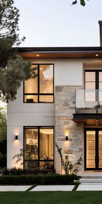 Contemporary profiles and oversized glass doors maximize natural light in U.S. residential architecture. Design subtraction and textured wall surfaces add visual interest to modern home design. Indoor-outdoor flow is prioritized in contemporary American house architecture.