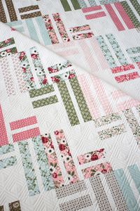 Top US Quilting Blog Lella Boutique shares the new "Stairway to Heaven" jelly roll quilt. Download the geometric quilt pattern here!